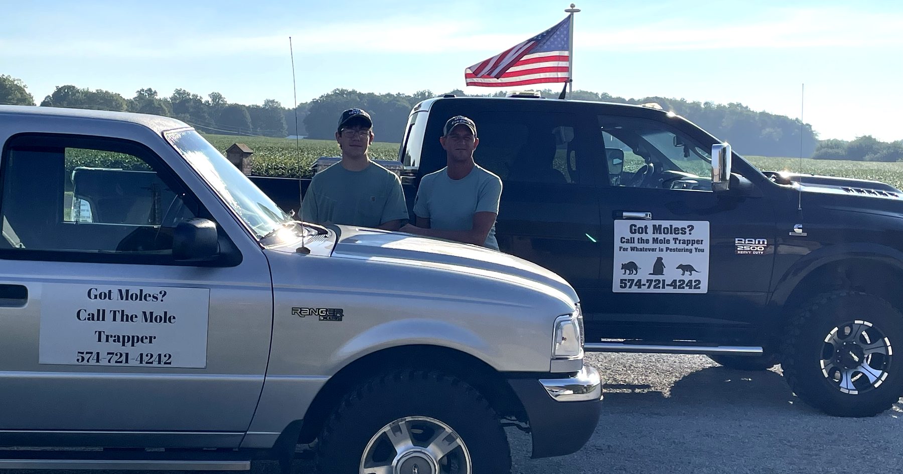 The Trapper Wildlife Removal crew with their service trucks at a field edge in Cass County, Indiana